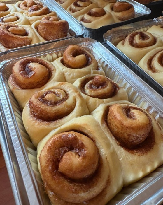 Trays of fresh cinnamon rolls from Farm Girl Bakery